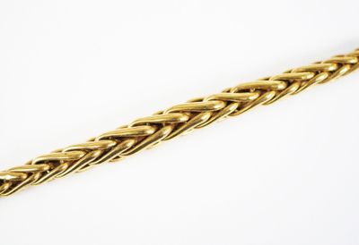 a close up of a gold chain on a white background