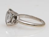 a close up of a diamond ring on a white surface