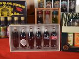 six bottles of soda sitting in a box on a table