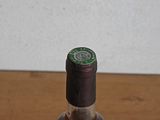 a bottle of liquor sitting on a wooden table