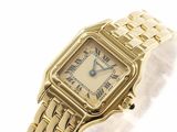 an image of a lady ' s gold watch with roman numerals