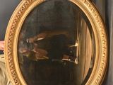 a man that is holding a mirror in his hand