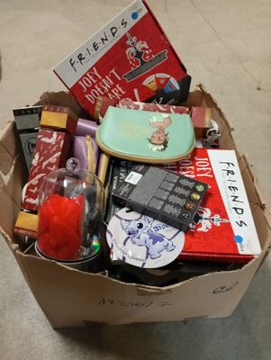 a cardboard box filled with assorted items on the floor