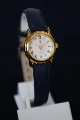 an image of a gold watch with roman numerals on the face