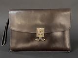 a brown leather purse with a gold metal clasp