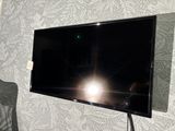 a flat screen tv mounted on a wall in a living room