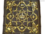 a black and gold scarf with a crown on it