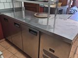 a kitchen with stainless steel counter tops and a dishwasher