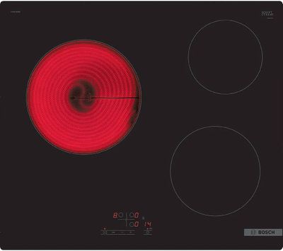 a black and red stove top with three burners on it