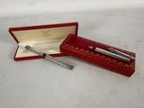 a close up of a pen in a red box on a table