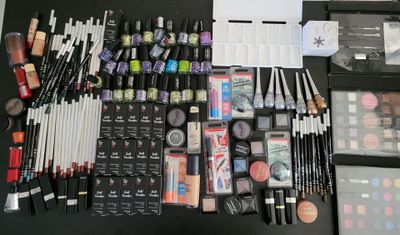 a lot of makeup and makeup brushes on the table