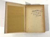 an open book with a handwritten note on it sitting on a table