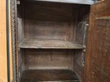 an old wooden cabinet with a shelf in it