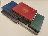 several books are stacked on top of each other on a table