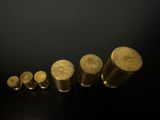 a lot of gold colored metal objects on a black surface