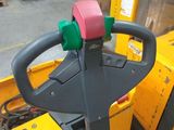 the forklift is parked in front of a stack of boxes