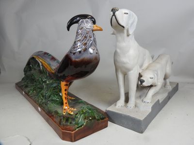 two figurines of a dog and a bird on display