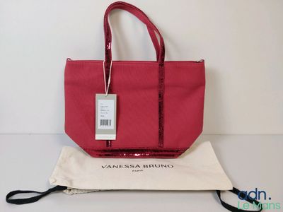 a close up of a red bag with a tag on it