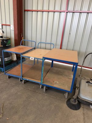 two tables and a cart in the garage