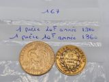 a close up of two gold coins in plastic bags on a table