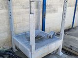 a metal platform that is sitting next to a wall