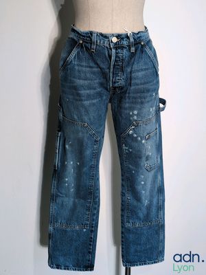 denim pants with holes on them on a mannequin dummy