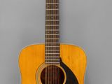 an image of a guitar hanging on a wall in a room