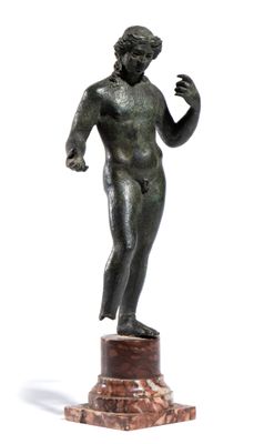 bronze statue of a man holding a tennis racquet on a marble base