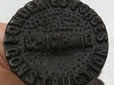 someone is holding a ring that has a small black coin on it