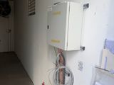 a room with a white wall and wires on the wall
