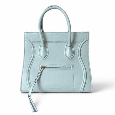 a blue handbag with a zipper on the front and a long handle