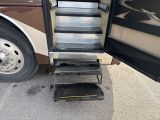 a bus that has a set of stairs going up to it