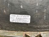 a close up of a black vase with a label on it