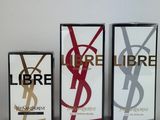three boxes of yves liberte perfume on a white surface