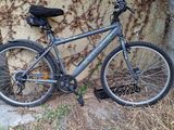 a bike that is parked against a rock wall