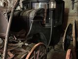 a horse and buggy in a room with a light on