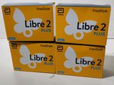 three boxes of libre 2 plus sitting on top of a table
