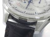 a close up of a watch with a leather strap