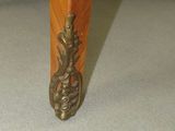 a close up of the legs of a wooden table with a metal handle