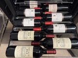 many bottles of wine sitting on a rack in the refrigerator