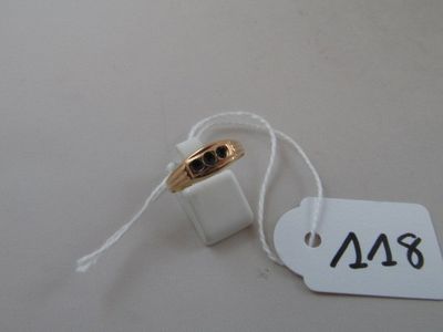 a white tag with a gold ring attached to it