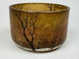 a brown bowl with trees on it on a white surface