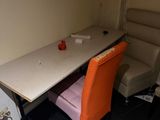 a table with two chairs and a chair in the corner