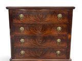 an antique chest of drawers with brass handles