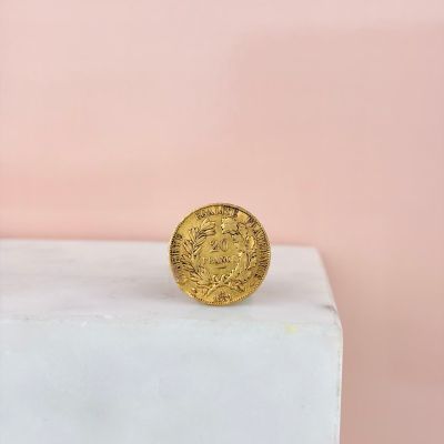 a gold coin sitting on top of a marble block