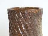 a brown vase that is sitting on a table