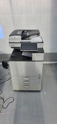 a printer sitting on top of a desk next to a computer