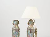 pair of chinese vases with handles and a lamp on a white background