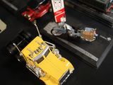 a yellow toy truck on a black table with other toy cars