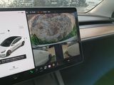 a laptop computer sitting on a car dashboard with a picture of a car in the background